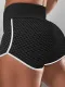 Pantalones cortos negros de yoga de levantamiento de glúteos con rayas en contraste de nido de abeja de cintura alta negros