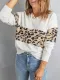 Suéter blanco de punto con cuello en V y bloques de color de leopardo