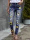 Jeans de cintura alta desgastados con estampado de girasol y patchwork de leopardo